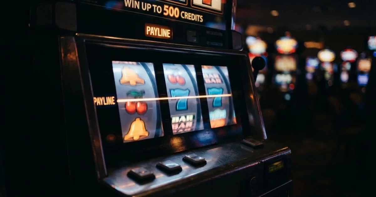 Rolos luminosos de uma slot machine numa sala escura, em grande plano — 10 euro casino em portugal